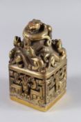 A LARGE CHINESE BRONZE FOO DOG SEAL. 7ins high x 3.5ins wide.