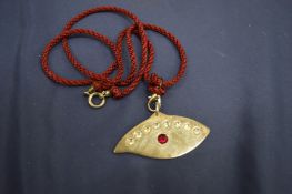 A decorative pendant, signed.