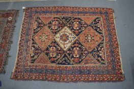 A Persian rug with geometric decoration, 187cm x 155cm.
