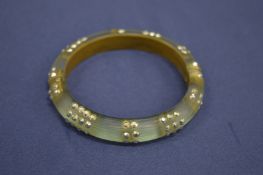 An Alexis Bittar bangle.