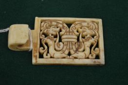 A Chinese and pierced white jade belt hook.