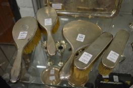 A five piece silver backed dressing table set.