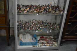 A large quantity of Del Prado cast metal figures and paperwork together with a display cabinet.