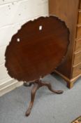A Georgian style mahogany tilt-top tripod table with pie-crust top.