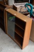 A bookcase with glass sliding doors.