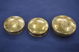 Three silver pill boxes.