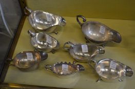 Seven various silver plated sauce boats.