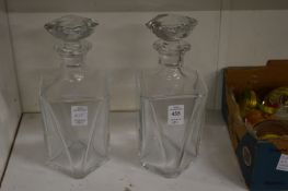 A pair of baccarat decanters (one cracked).