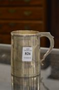 A silver Christening mug.