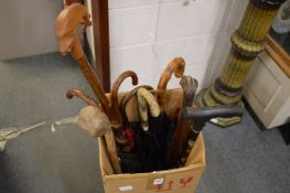 A collection of walking sticks, parasols and umbrellas.