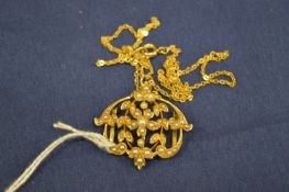 A 15ct gold and seed pearl pendant/brooch with chain.