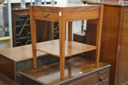 A two-tier single drawer lamp table.
