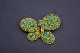 A Kenneth Lane turquoise brooch.