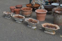 A set of four weathered cast iron garden plant troughs.
