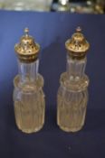 Two silver mounted cut glass bottles.