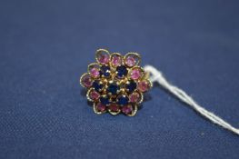 An 18ct gold and gem set flower head cluster ring.