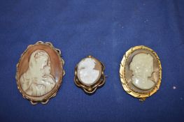 Three cameo brooches.