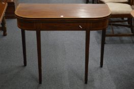 A George III mahogany and rosewood banded D shaped fold-over tea table.