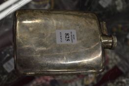 A silver hip flask with captive top.