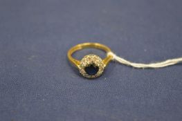 An 18ct gold, diamond and sapphire ring.
