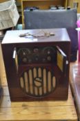 An early battery operated radio with mahogany stained cabinet.