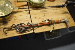 Three riding crops, two with silver mounts.