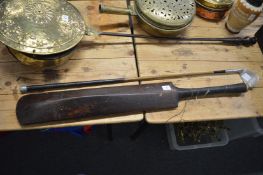 An old cricket bat and golf club.