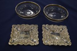 A pair of cut glass silver bon-bon dishes and a pair of silver rimmed cut glass dishes.