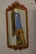A gilt framed mirror.