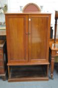 A mahogany two door cabinet with fitted interior.