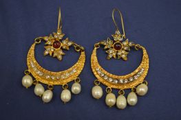 A pair of decorative earrings.
