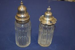 A pair of silver topped cut glass jars.