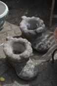 A pair of composite boot shaped garden planters.
