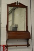A Victorian mahogany hall mirror with storage compartment.
