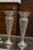 A pair of embossed silver bud vases, Chester 1903.