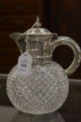 A cut glass claret or water jug with silver mounts, Birmingham 1890.