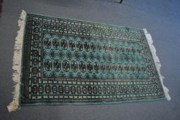A modern Bokhara style green ground rug, 155cm x 97cm.