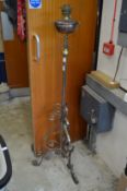 A telescopic wrought iron floor standing oil lamp.