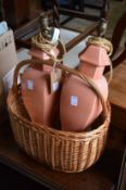 A wicker basket and pair of table lamps.
