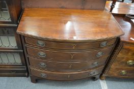 An American reproduction mahogany bow front chest of four long drawers.