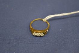 An 18ct gold and diamond three stone ring.