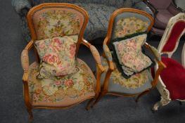 A pair of French style beech framed needlework upholstered open armchairs.