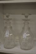 A pair of cut glass ring neck decanters and stoppers.