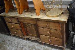 An oak and hardwood dresser base.