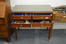 A mahogany four drawer floor standing cutlery canteen containing large quantity of plated flatware.