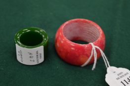 A Xiu Yu plum jade archers ring and another archers ring.