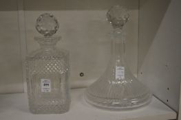 A whisky decanter, rim chipped together with a port decanter.