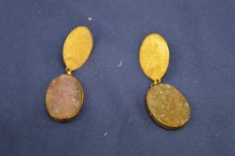 A pair of decorative earrings.