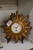 A Cartel sunburst clock with enamel dial.