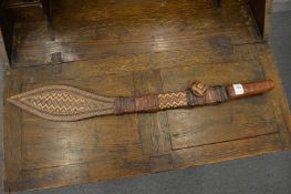 An African sword with decorative leather scabbard.